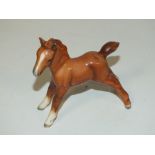 A BESWICK CHESTNUT FOAL FIGURE