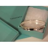 A TIFFANY STYLE BANGLE WITH BOX AND BAG