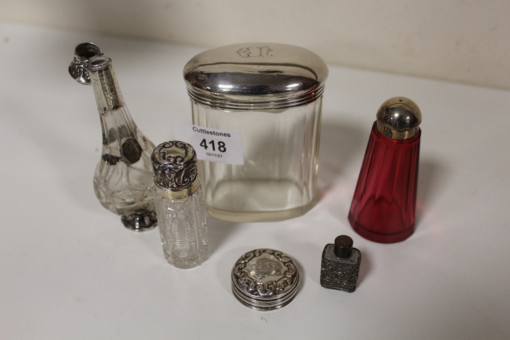 TWO SILVER AND CUT GLASS SCENT BOTTLES, ONE BADLY CRACKED, TOGETHER WITH A HALLMARKED SILVER TOP