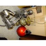 A BOX OF ASSORTED METALWARE TO INCLUDE A CONVERTED OIL LAMP, SODA SYPHON, CANDLE STICKS ETC.