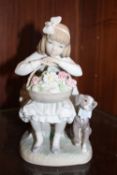 A LLADRO FIGURE OF A SEATED YOUNG GIRL HOLDING A BASKET OF FLOWERS NEXT TO A SEATED DOG, H 21.5 CM
