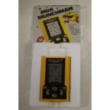 A BOXED MINI MUNCHMAN LCD POCKET ARCADE GAME, with instructions