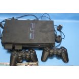 A PLAYSTATION 2 WITH CONTROLLERS, together with Grand Theft Auto game and related magazine