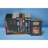 A SMALL TRAY OF STAR WARS DVDS AND VHS VIDEOS, to include The Empire Strikes Back