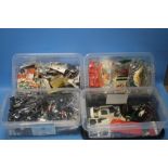 FOUR SMALL STORAGE BOXES WITH CONTENTS, including model parts, wheels, tyres, figures etc.