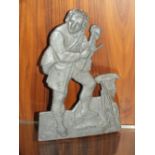 A VINTAGE CAST METAL PLAQUE IN THE FORM OF A MAN WITH A VIOLIN