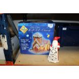 A BOXED FIBRE OPTIC ICICLE CHURCH CHRISTMAS DECORATION TOGETHER WITH A SANTA SHAPED CANDLE HOLDER