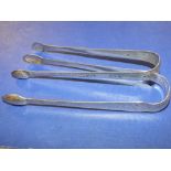 TWO PAIRS OF GEORGIAN BRIGHT CUT SUGAR TONGS