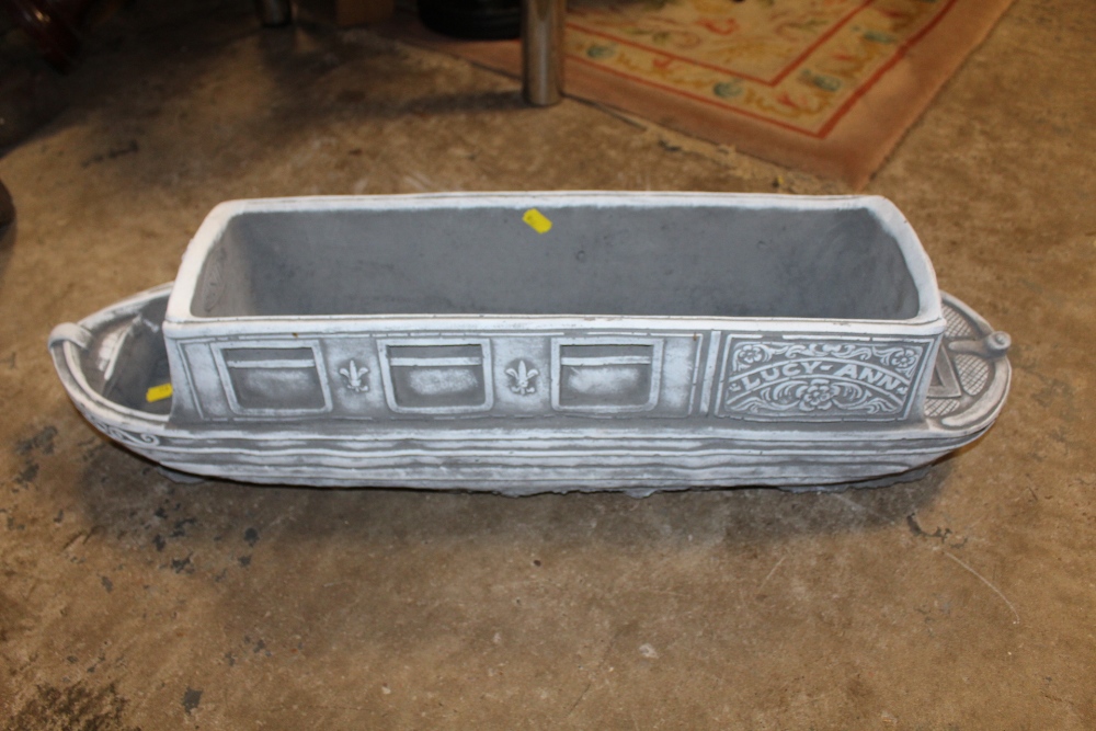 A CAST GARDEN PLANTER IN THE FORM OF A NARROW BOAT