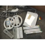 A NINTENDO WII CONSOLE WITH ACCESSORIES AND GAMES