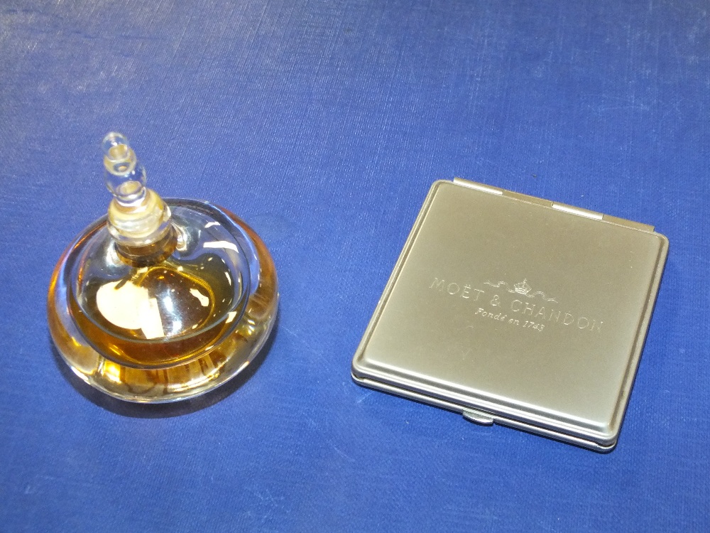 A PART BOTTLE OF AMOUAGE PERFUME, AND A MOET & CHANDON COMPACT MIRROR
