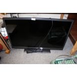 A HITACHI 32" FLATSCREEN TV WITH REMOTE