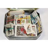 A TIN OF CIGARETTE CARDS, [POSTCARDS AND STAMPS