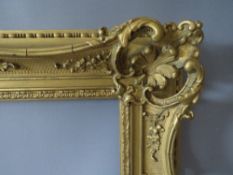 A 19TH CENTURY PIERCED AND SWEPT GOLD FRAME, frame W 9 cm, rebate 50 x 35.5 cm