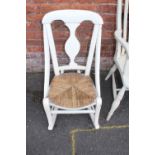 A CREAM PAINTED TRADITIONAL WINDSOR STYLE ARMCHAIR, together with a cream painted rush seated