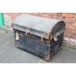 A LARGE VINTAGE DOMED TRAVELLING TRUNK, with leather carry handles, with original paper tag 'T.A.