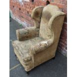 A VINTAGE UPHOLSTERED WINGBACK ARMCHAIR, with hand stitched detail, seat height 42 cm, back height