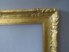 A LATE 19TH / EARLY 20TH CENTURY DECORATIVE GOLD FRAME WITH GOLD SLIP, frame W 45 cm, slip rebate