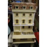 A LARGE WOODEN DOLLS HOUSE H 141 CM, including stand