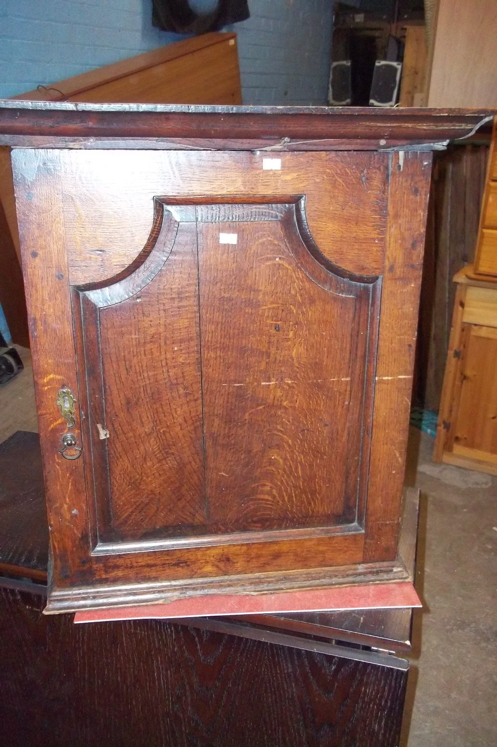 AN ANTIQUE OAK WALL CABINET