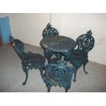 A CAST IRON BRITTAVIA DESIGN GARDEN TABLE AND FOUR MATCHING CHAIRS