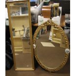 AN OVAL FRAMED MIRROR TOGETHER WITH AN OBLONG MIRROR