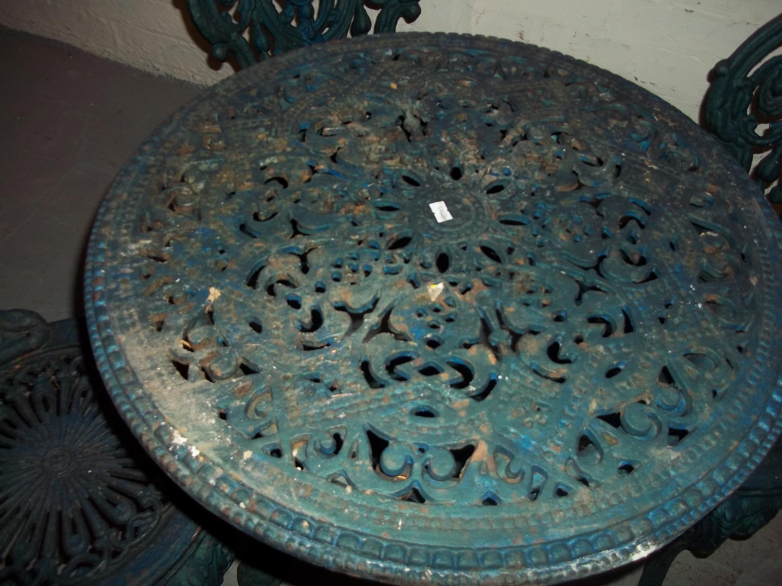 A CAST IRON BRITTAVIA DESIGN GARDEN TABLE AND FOUR MATCHING CHAIRS - Image 2 of 3