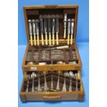 A PART CANTEEN OF CUTLERY IN ART DECO OAK BOX