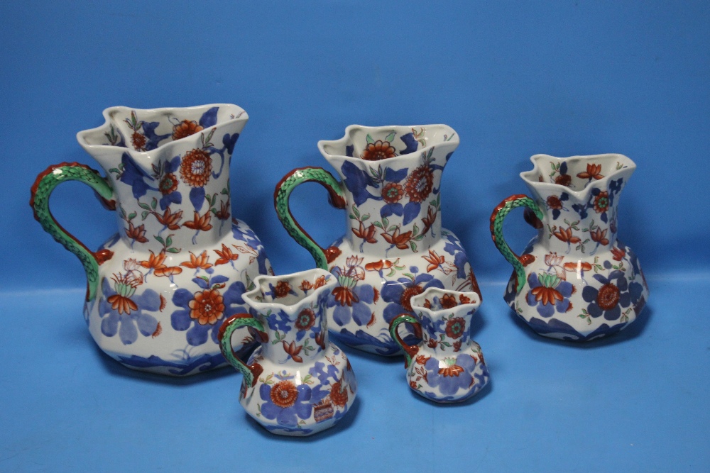 A GRADUATED SET OF FIVE IRONSTONE JUGS