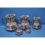 A GRADUATED SET OF FIVE IRONSTONE JUGS