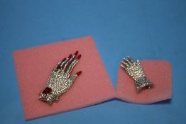 TWO BOXED "BUTLER & WILSON" HAND BROOCHES (2)