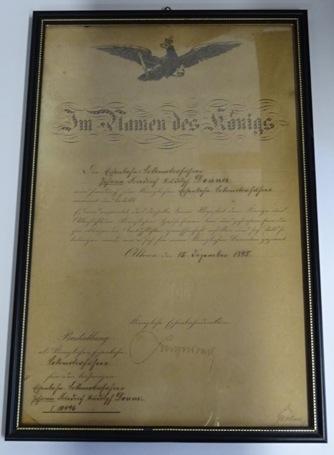 Bestallungsurkunde zum Lokomotivführer von 1895, "Eisenbahn-Direction Altona", gerahmt, 34,5x23 cm