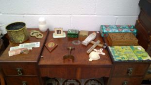 A wide array of different world items, including a mix of money, incense boxes, a brass planter,