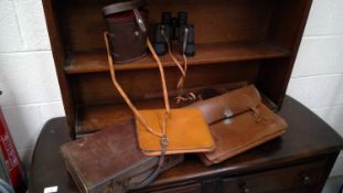 A small vintage leather suitcase, vintage leather satchel, pigskin case, Regent 8X40 binoculars, and