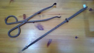 Vintage fire poker and tongs.