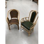 A cane and wicker armchair with leather seat and back, and another ane and wicker armchair.