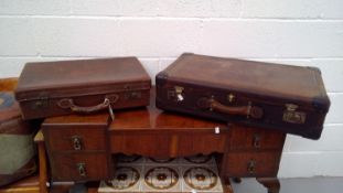 A pair of vintage suitcases.