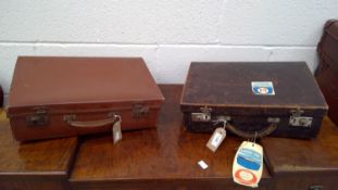 A vintage leather travel case with a vintage leather suitcase.