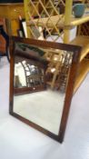 Mahogany wall hanging mirror with a beveled edge. Height 68cm width 52.5cm