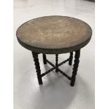Brass Benares style table on folding base, 60cm diameter.