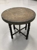 Brass Benares style table on folding base, 60cm diameter.