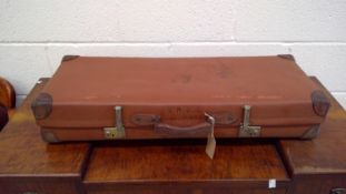 A single vintage 'Revelation' suitcase.