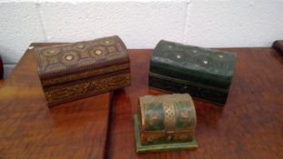 Tooled leather casket, another similar, and a small wooden casket with brass mounts.