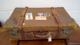 A large vintage suitcase, damage at the handle.