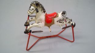 Vintage tin "Mobo prairie king" rocking horse.