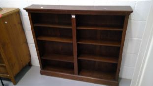 A twin bay open oak bookcase height 107cm width 124cm depth 21.5cm