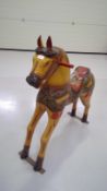 Wood carved and painted model of a horse, height 97cm width 84cm depth 30cm.