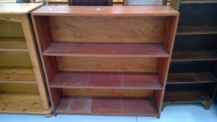 Teak open bookshelves. Height 93cm, width 95cm, depth 23.5cm.