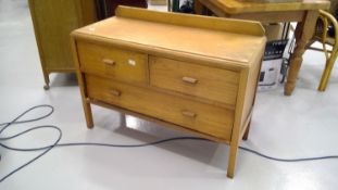 An Oak chest of low drawers, two short and one long. Height 70cm, width 105cm, depth 34cm