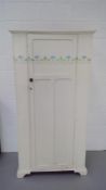 A white-painted and stencilled single wardrobe on bracket feet height 182CM width 93.5cm depth 56.